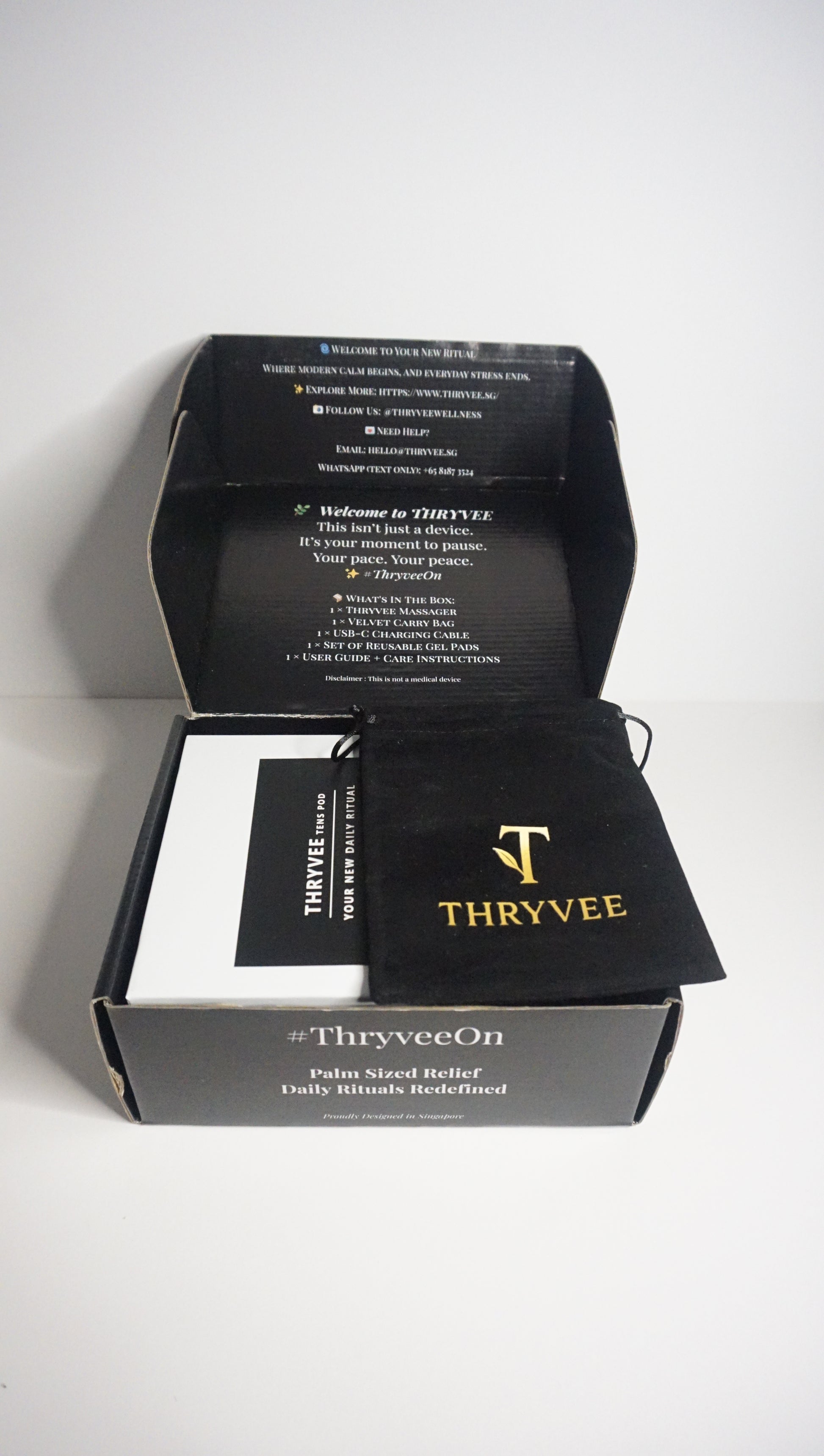 White Thryvee portable massager with modern design